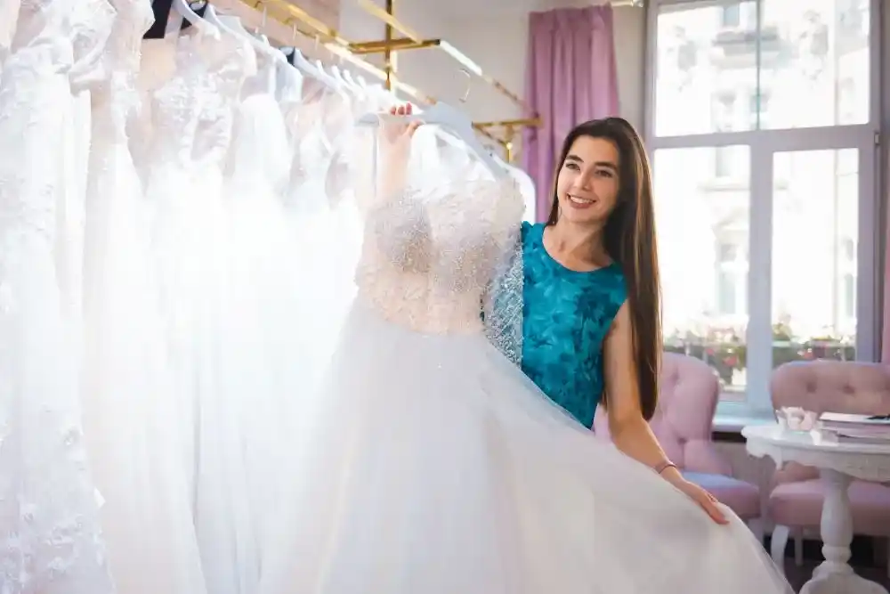 happy-bride-chooses-a-dress-in-a-wedding-boutique